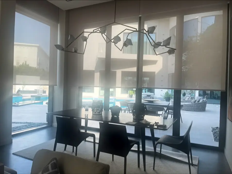 Screen roller blinds in a dining area, photo from the Blindtex Google listing